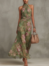 Green floral halter-neck maxi dress with a sheer overlay, front view
