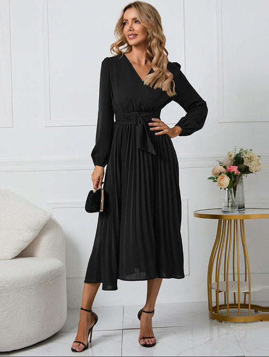 Pleated midi dress showing the waist tie and draped skirt