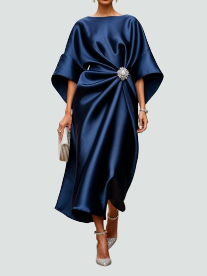 Draped midi dress with a statement brooch at the waist, front view