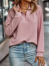 V-neck sweater with a zip detail at the neckline, front view