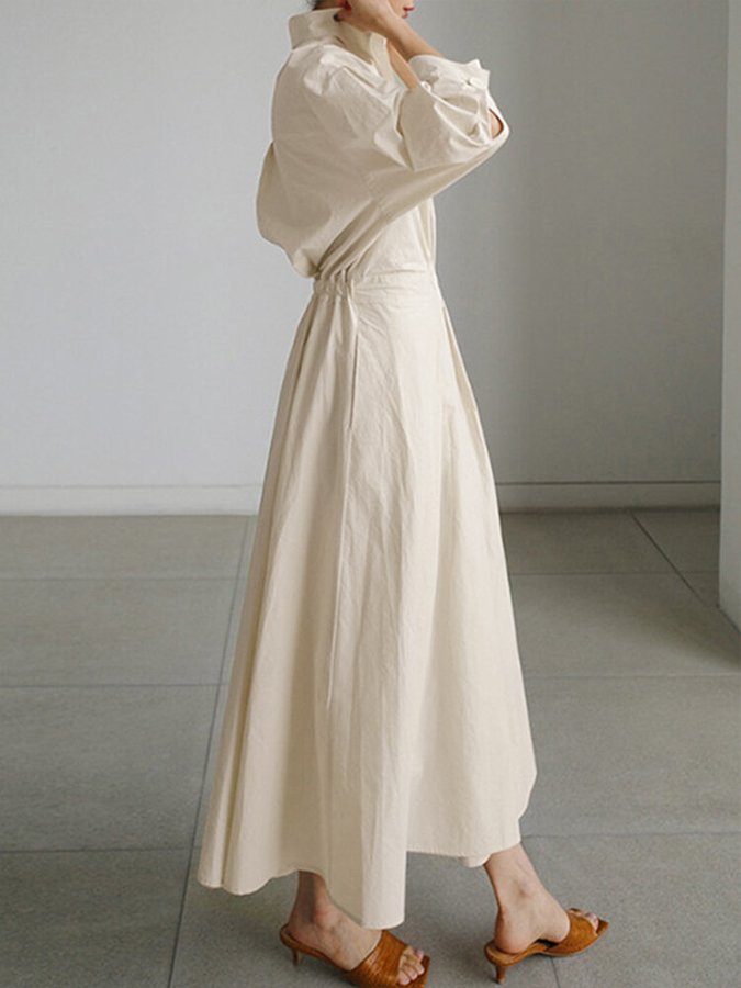 Long-sleeve collared dress showing the flowing skirt