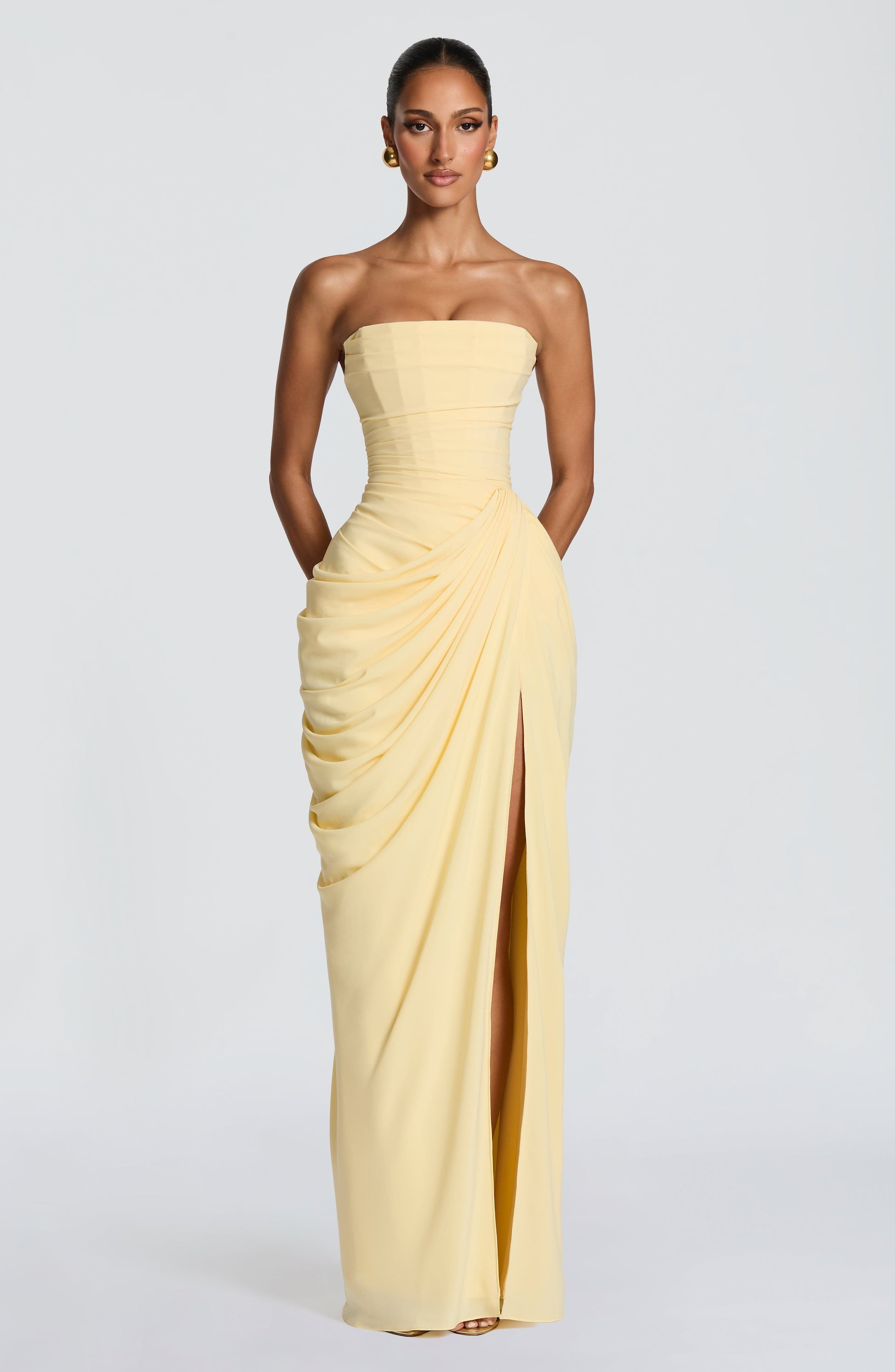 Corset maxi dress showing the asymmetrical hip draping