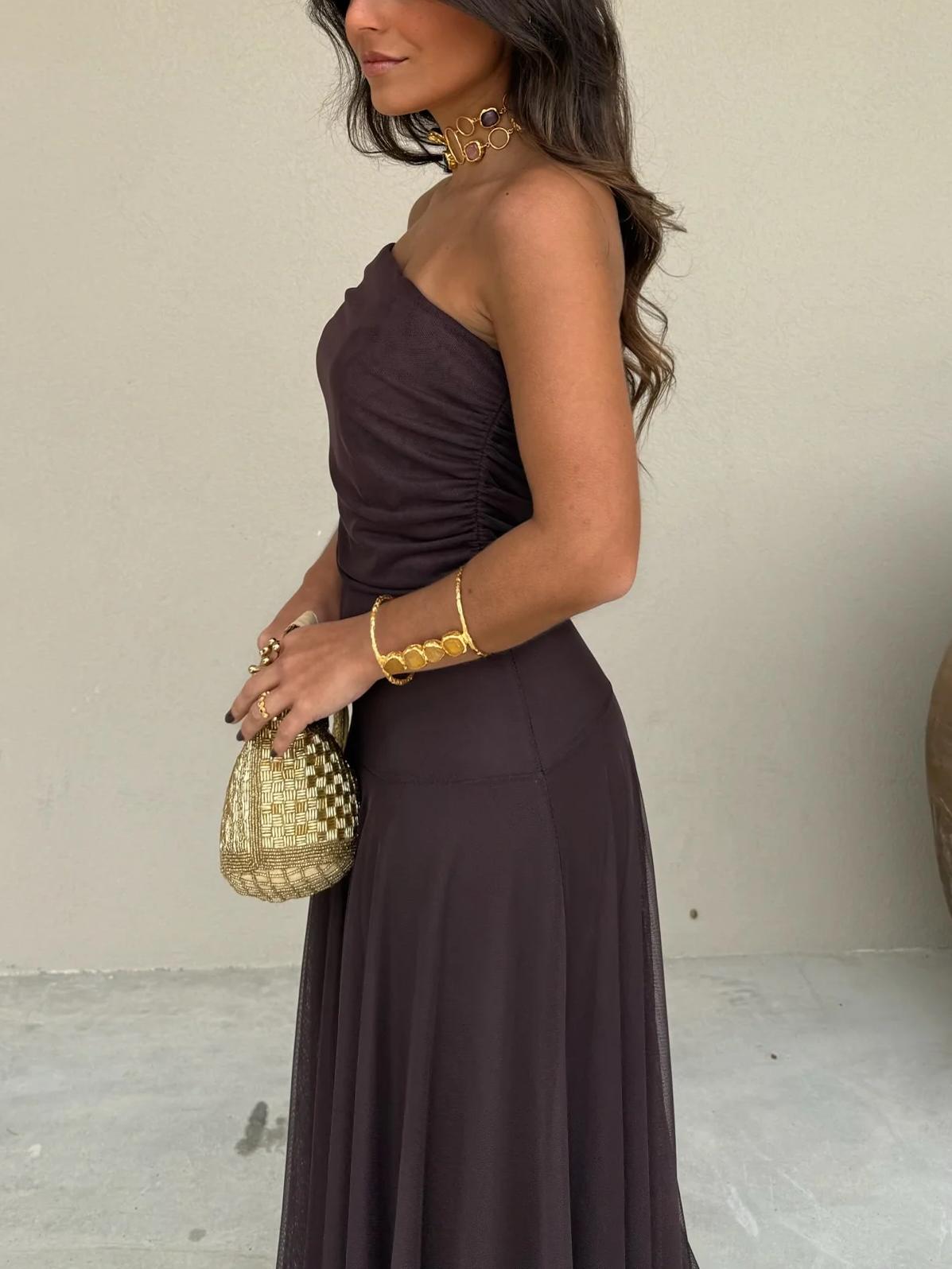 Close view of the mesh overlay on a brown dress