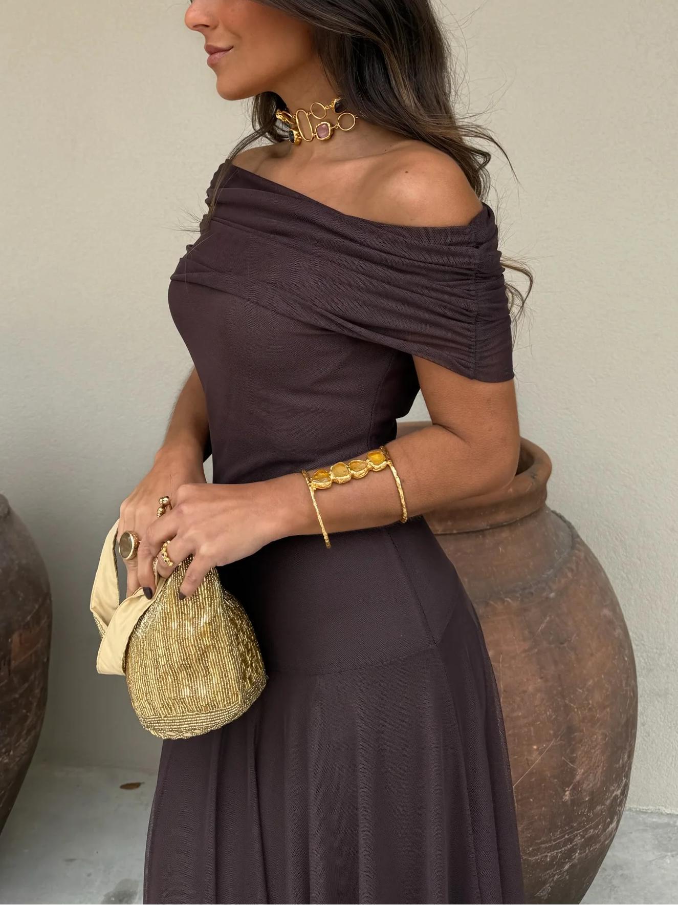 Brown one-shoulder dress showing the floor-length drape