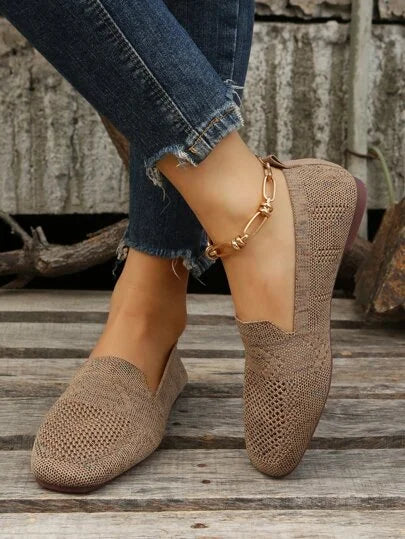 Knit loafers showing the open perforated pattern across the toe