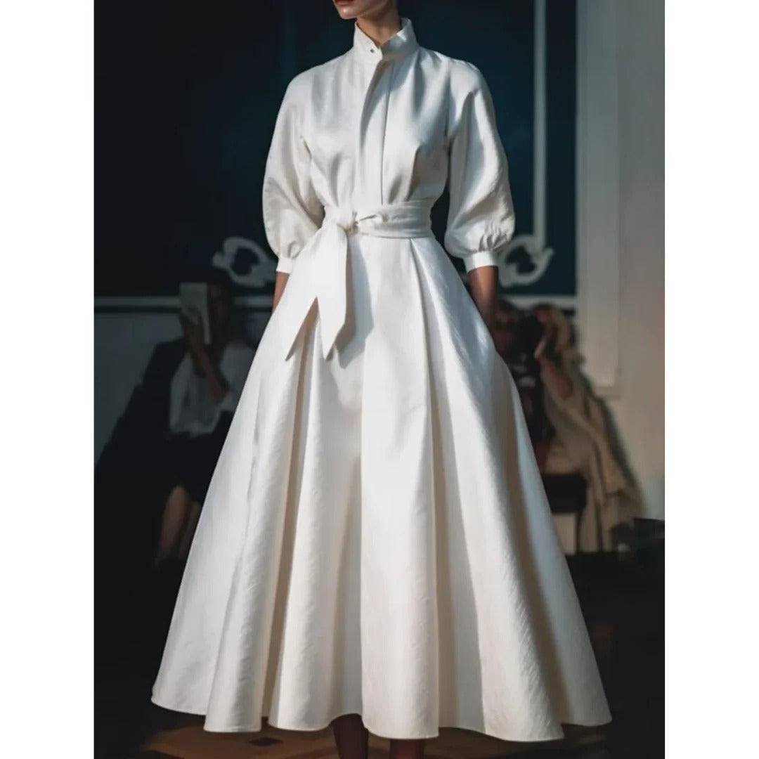 White midi dress showing the A-line skirt and V-neck