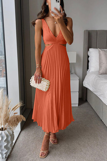 Sleeveless pleated dress photographed at an angle